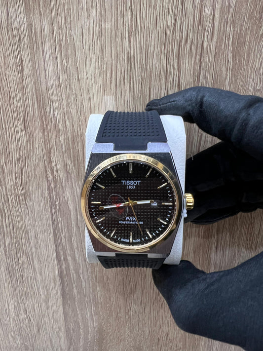 TISSOT PRX – CADRAN NOIR, LUNETTE DORÉE & BRACELET NOIR